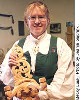 Becky Lusk holding a candleholder in Ancanthus style.  Photo by Jeanie Geurink.