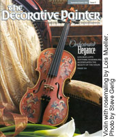Violin with rosemaling by Lois Mueller on the cover of "The Decorative Painter" Magazine.